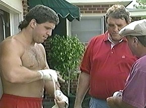 PETER McNEELEY WRAPS HAND AS TRAINERS LOOK ON - IMAGE#1