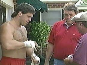 PETER McNEELEY WRAPS HAND AS TRAINERS LOOK ON - IMAGE#2