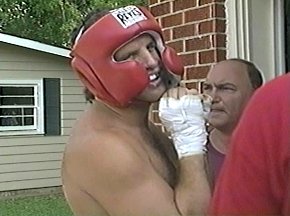 PETER McNEELEY REMOVES HIS HEADGEAR AFTER WORKOUT