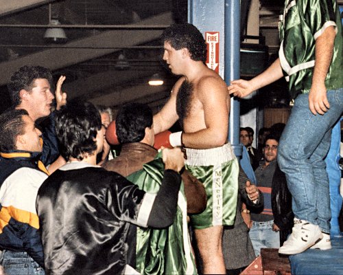 HEAVYWEIGHT BOXER PETER McNEELEY SURROUNDED BY FANS AFTER WINNING FIGHT