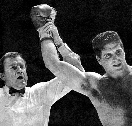 REFEREE LIFTS PETER McNEELEY'S ARM AFTER KO VICTORY